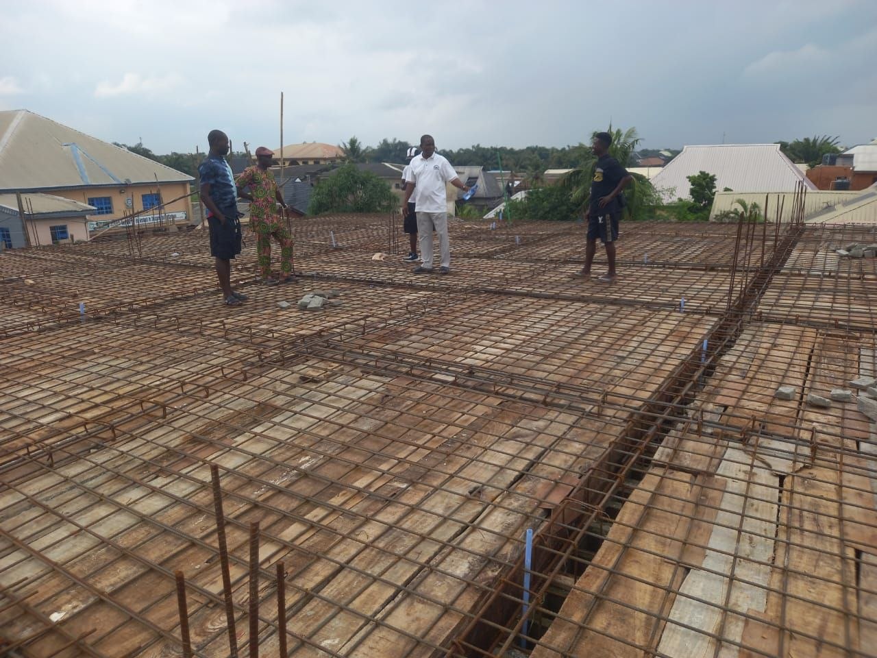 Workers standing on roof slab reinforcement mesh